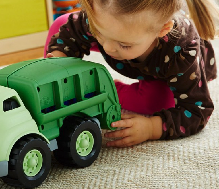 baby playing with toy truck